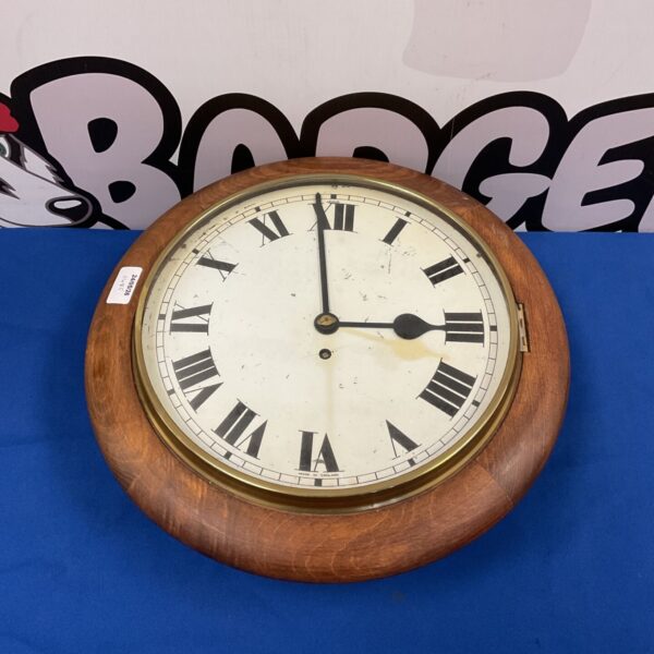 Victorian wall clock by Camerer Cuss & Co. with Roman numerals.