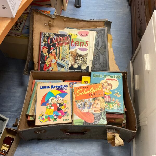 Case of vintage annuals with colourful illustrated covers.