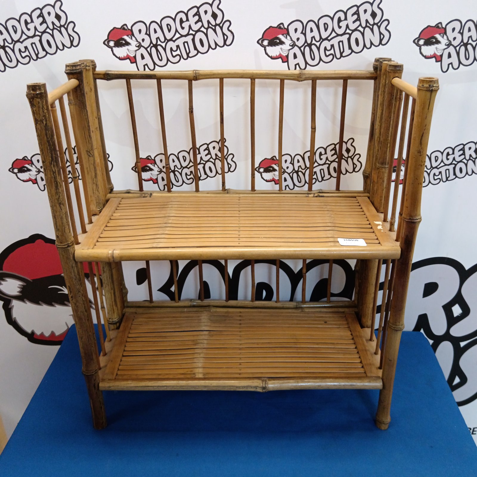 Vintage bamboo bookshelf with three tiers, ideal for books and display.