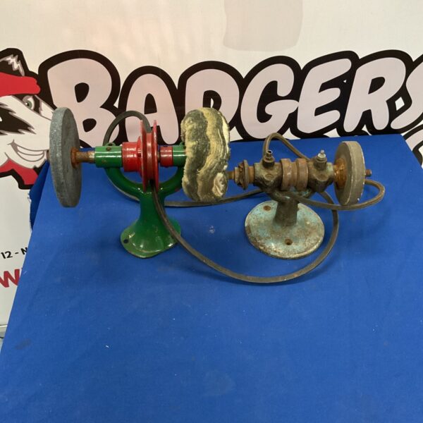 Vintage belt driven tool setup with cast iron components.