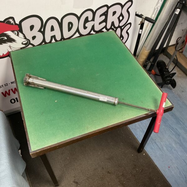 Vintage metal bike pump with wooden base.
