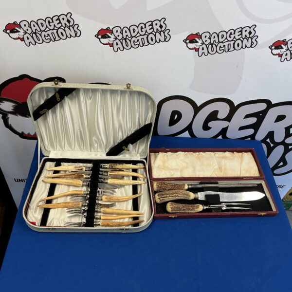 Vintage bone handle cutlery sets displayed on a patterned surface.