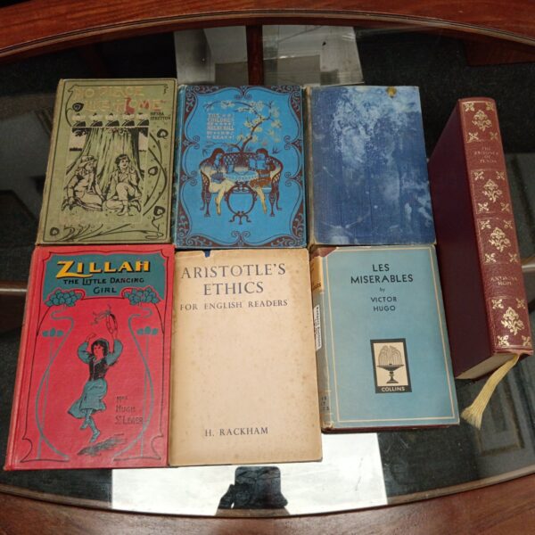 Vintage book collection featuring Les Miserables and Zillah.