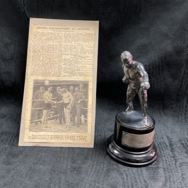 Vintage boxing trophy with newspaper clipping, Jimmy Carr award.