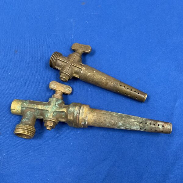 Vintage brass beer tap with lever handle and perforated spout.