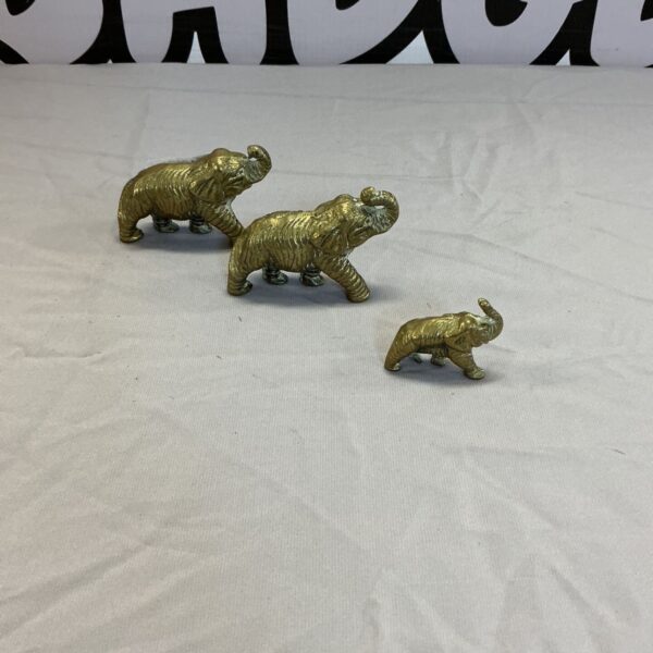 Vintage brass elephant figurines, a charming collectible set.