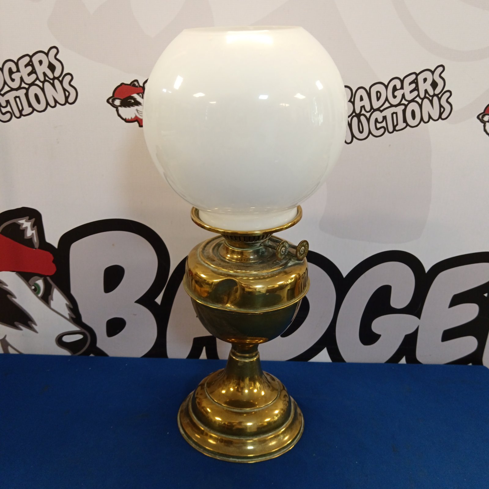 Vintage brass oil lamp with clear glass shade.