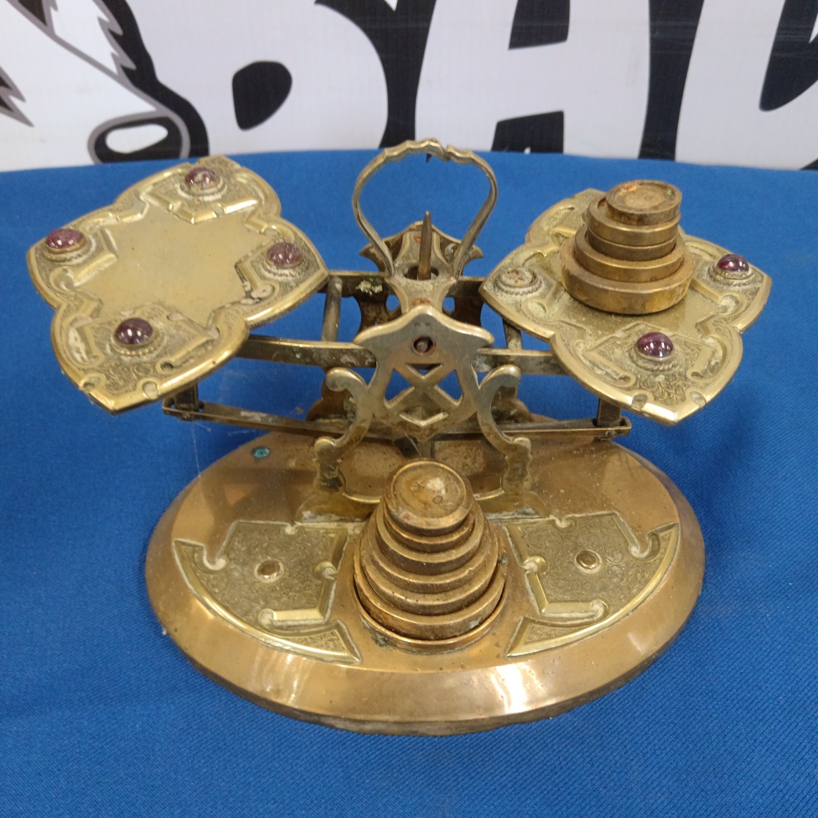 Vintage brass Art Nouveau scales with weights on display.