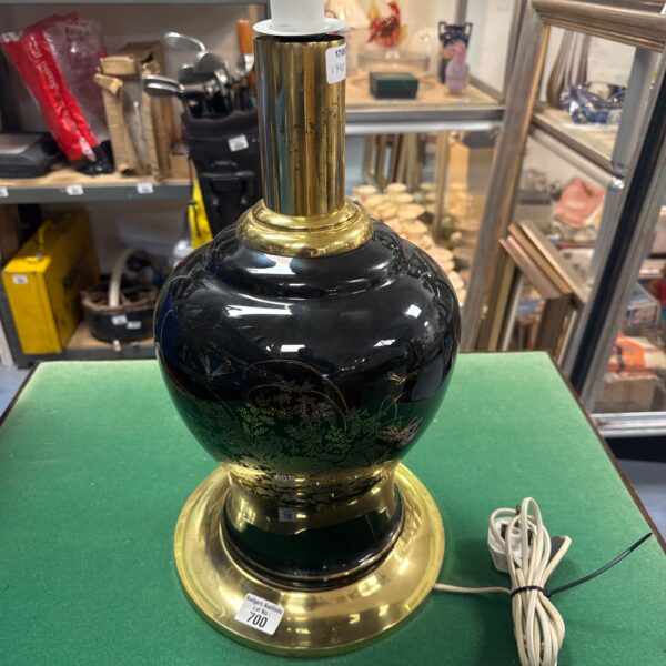Vintage brass table lamp with gold detailing, a classic decorative piece.