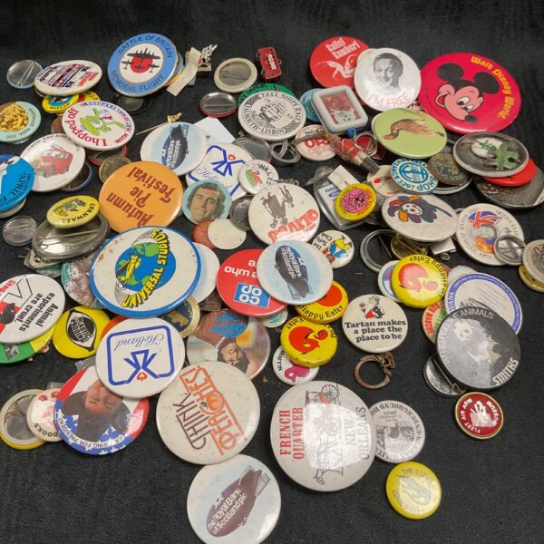 Large collection of vintage button badges and pin badges.