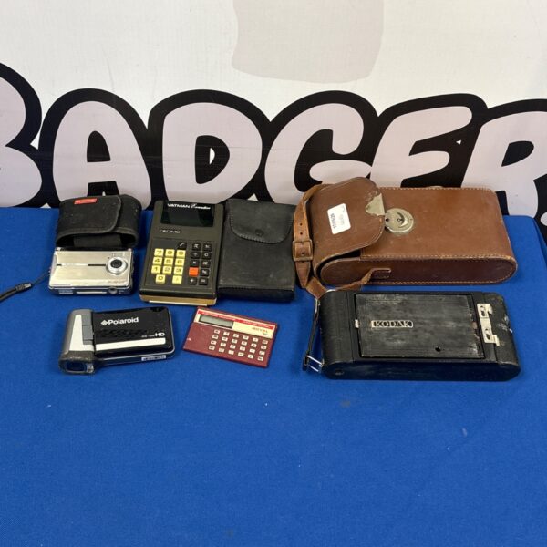 Vintage lot of cameras and calculators, including a Kodak camera.
