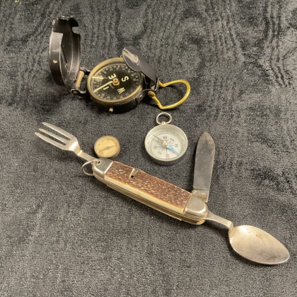 Vintage camping kit with compasses and pocket knife fork spoon.