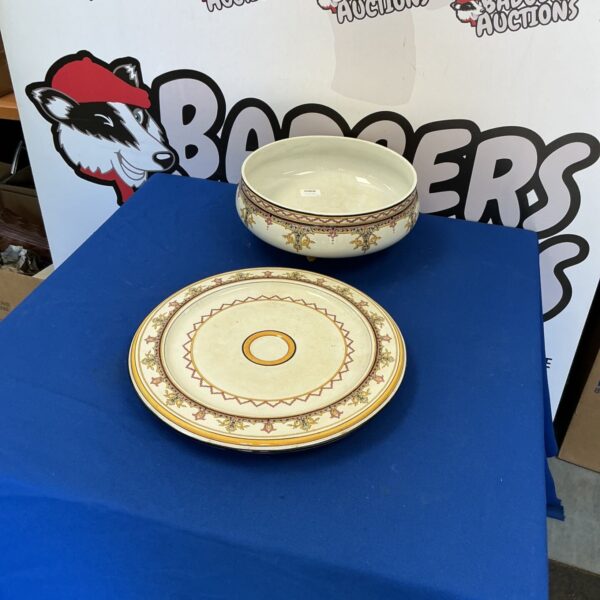 Vintage ceramic bowl with floral design and gold trim.