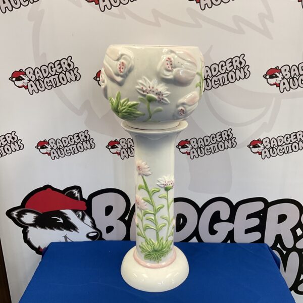 Vintage ceramic jardiniere stand with floral design.