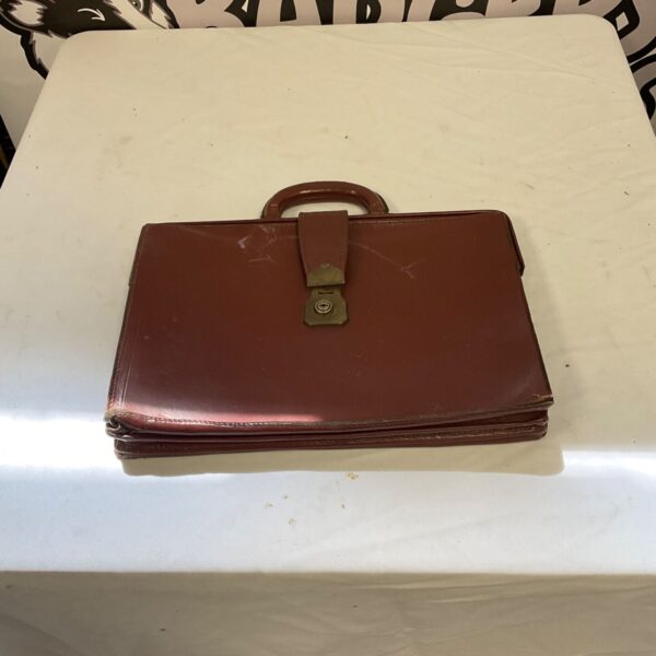 Vintage Cheney chestnut brown leather briefcase with buckle closure.