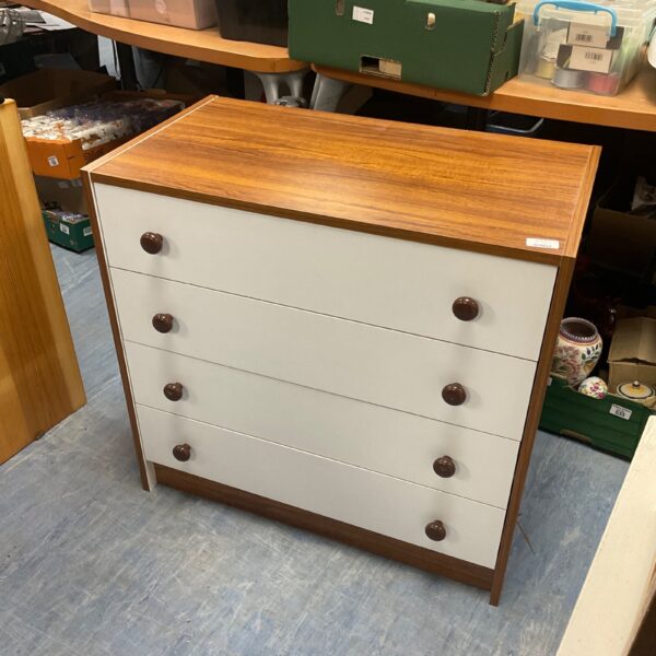 Vintage four-drawer chest of drawers with wood frame.