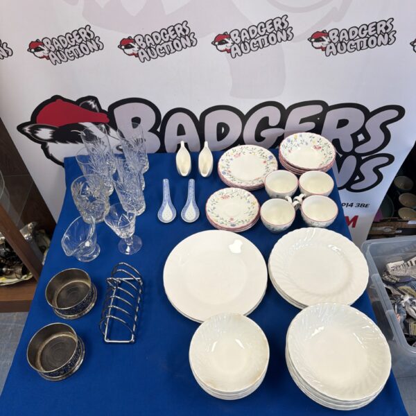 Display of vintage china lot with plates and teacups.