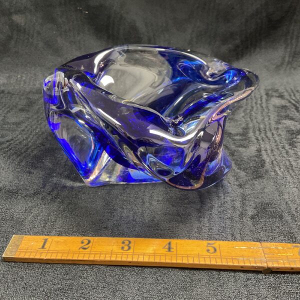 Vintage cobalt blue glass bowl with ruler for scale.