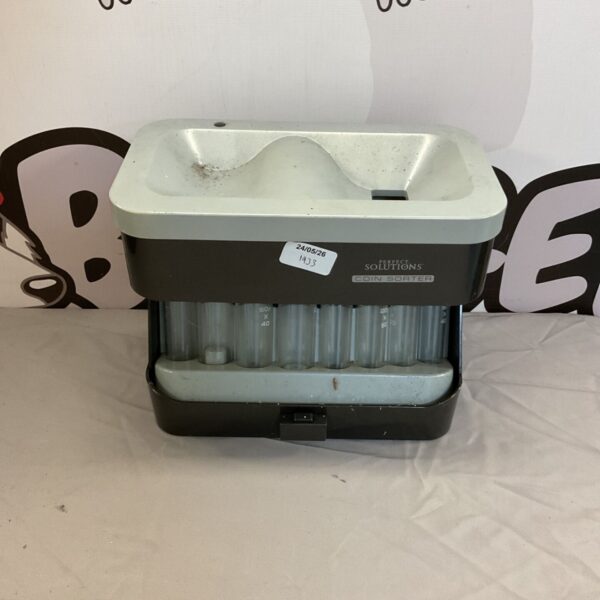 Vintage coin sorter for organising and counting loose change.