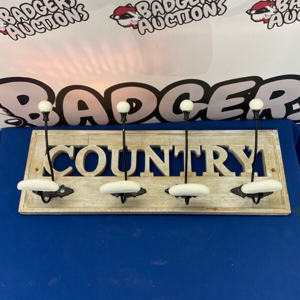 Vintage country coat hanger with three hooks for rustic farmhouse decor.