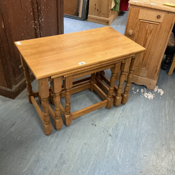 Vintage County Pine nest of tables in warm wood tones.