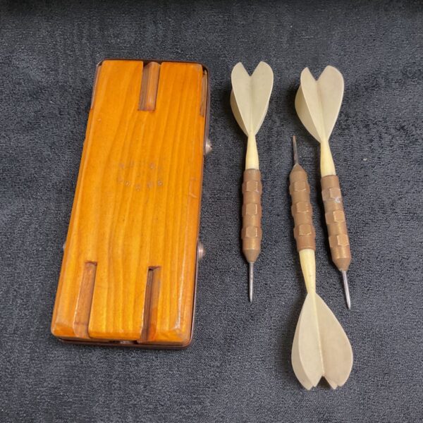 Vintage wooden dart case with sliding lid, showing age and patina.