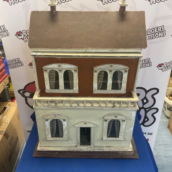 Front view of a vintage scratch-built wooden dolls house.