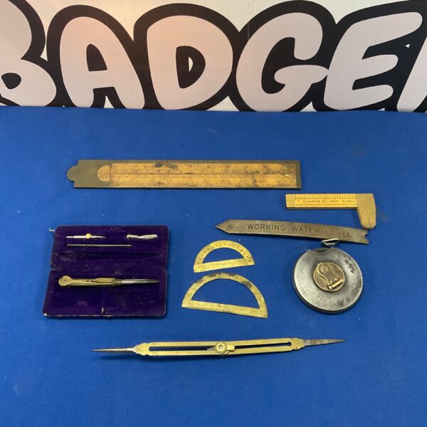 Vintage draughtsman’s tools lot including compass and dividers.
