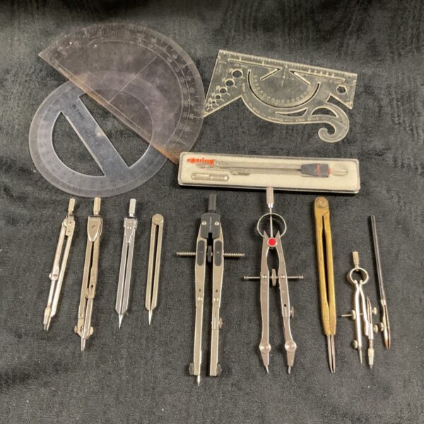 Vintage drawing instruments including Rotring compass and set square.