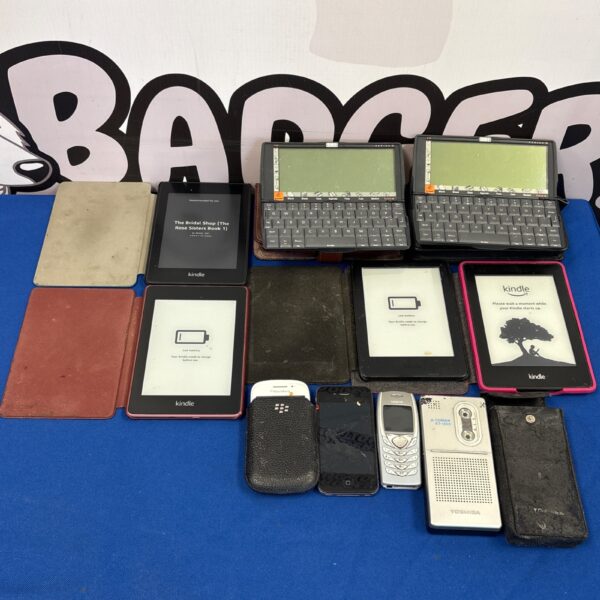 Vintage electronics lot including Kindles, Psion organisers, and mobile phones.