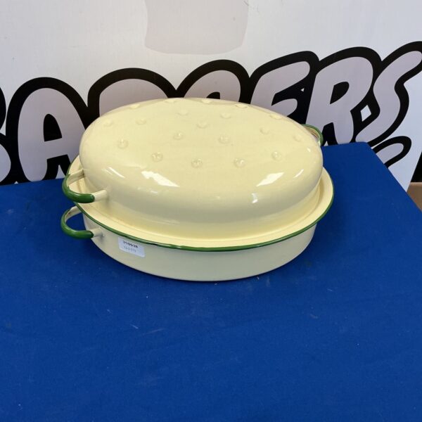 Vintage enamelled cooking pot with green rim and handles.