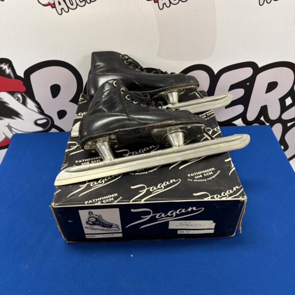 Vintage Fagan Pathfinder ice skates with worn leather and metal blades.