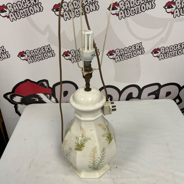 Vintage ceramic table lamp with fern pattern.