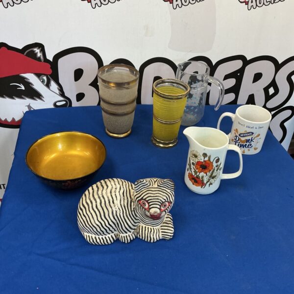 Vintage collectible figurines including a porcelain cat and decorative jug.