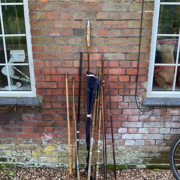 Bundle of vintage fishing rods including a Hardy fly fishing rod.