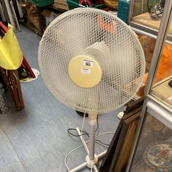 White vintage floor standing fan with oscillating head.
