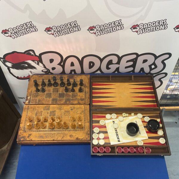 Vintage folding chessboard and backgammon set with wooden pieces.