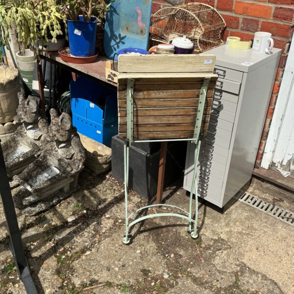Vintage folding garden chair with wooden slats and green metal frame.