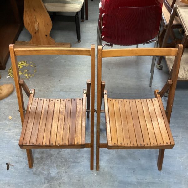 Pair of vintage mahogany folding chairs, classic design.
