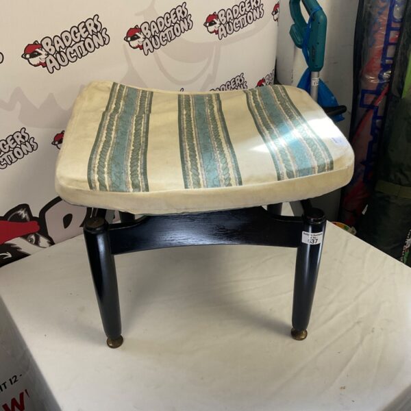 Vintage upholstered footstool with cushioned top, retro home decor.