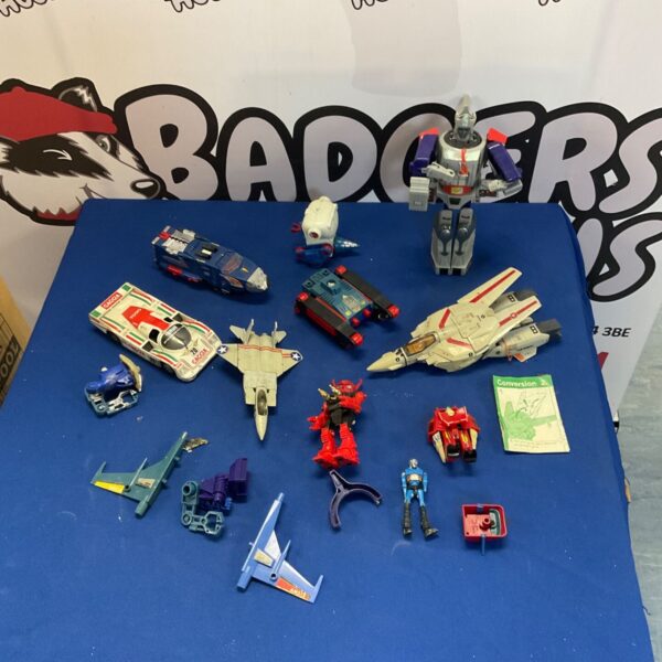 Vintage G1 Transformers lot including various action figures and transforming toys.