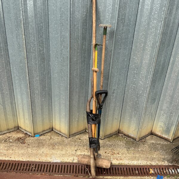 Vintage garden tool set with spade, fork, and hand tool.