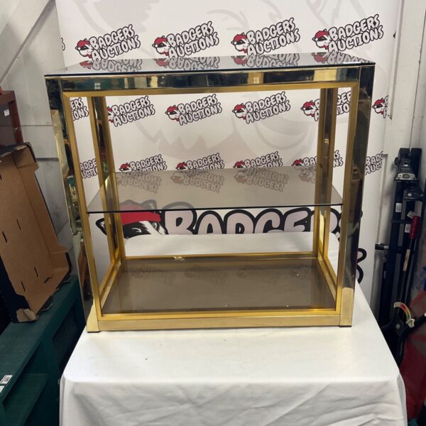 Vintage glass display cabinet with brass frame and shelving.