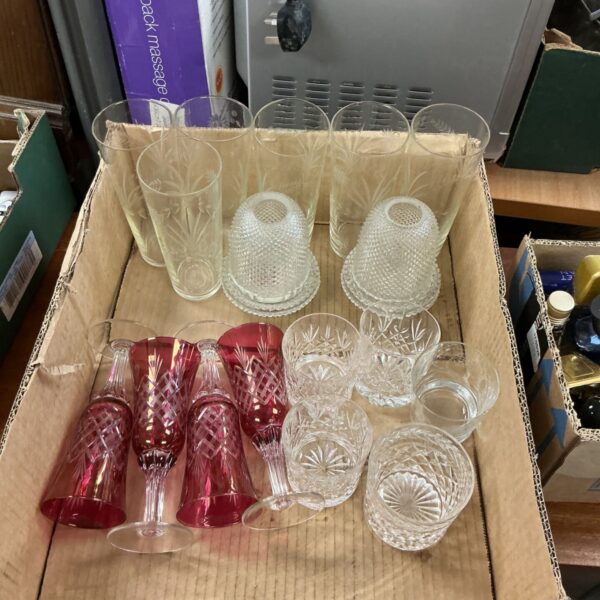 Vintage etched glassware including pink goblets and stemmed glasses.