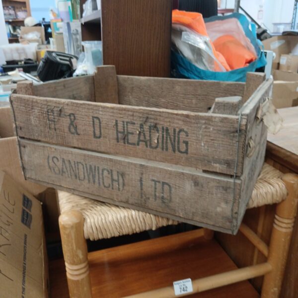 Vintage H & D Heading wooden crate on a chair.