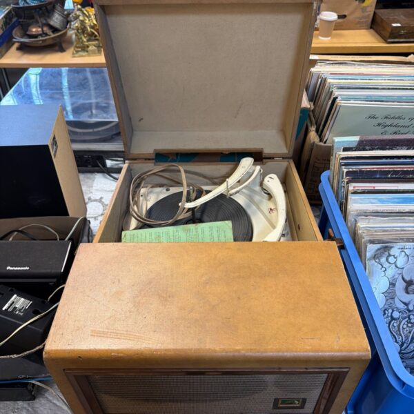 Closed vintage HMV record player with wooden case.