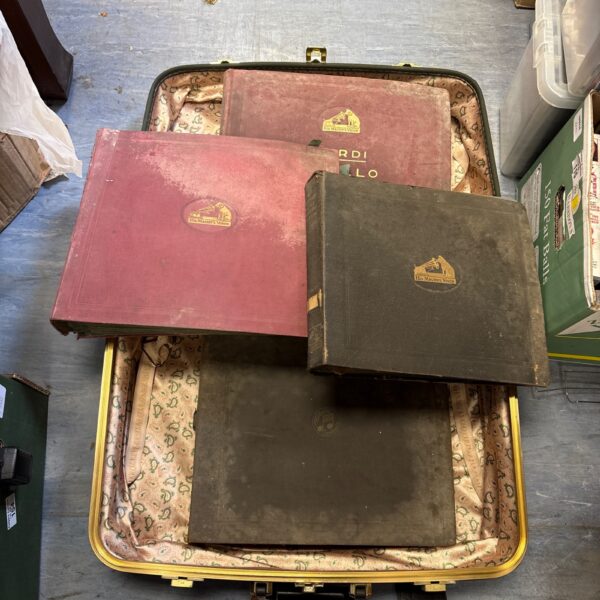 Vintage His Master's Voice records in a patterned suitcase.