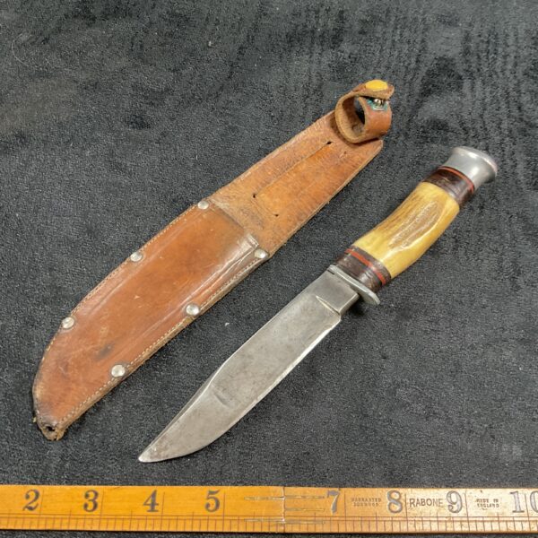 Vintage horn handle sheath knife with leather sheath.
