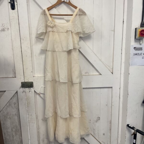 Vintage ivory wedding dress with lace details, 1970s style.