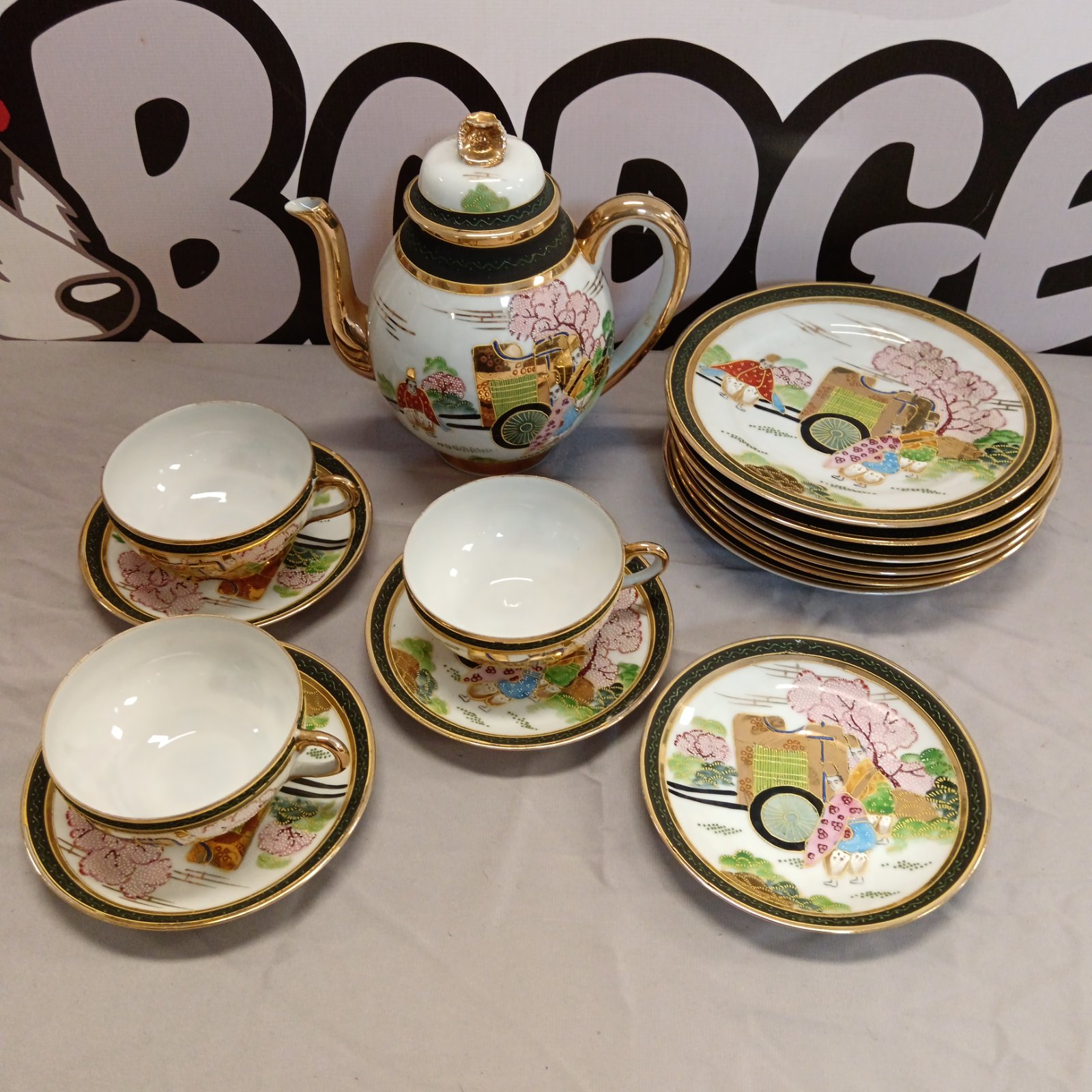 Vintage Japanese tea set with hand-painted floral designs.
